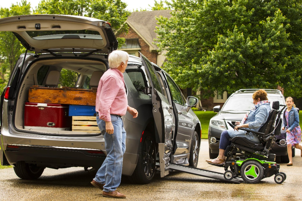 a family getting ready to go on a trip in the handicap van for rent