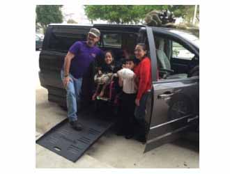 Lauren and her family pose by their new BraunAbility side-entry vehicle