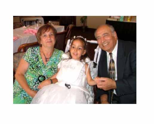grandparents with their granddaughter who is in a wheelchair