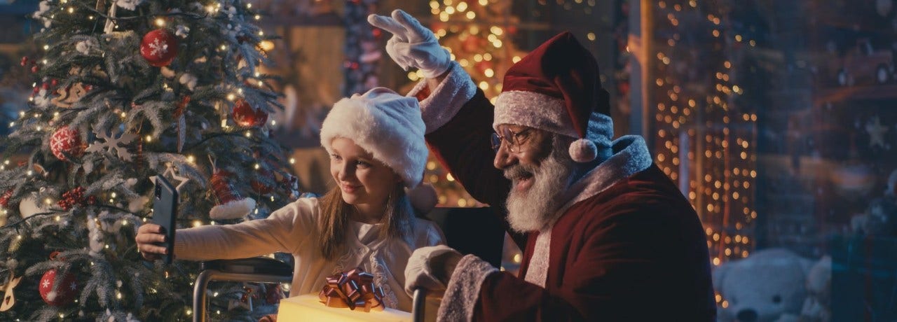 girl taking a photo with santa