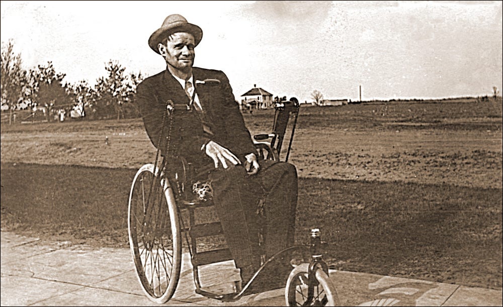 History of a wheelchair a vintage photo of a man in a wheelchair