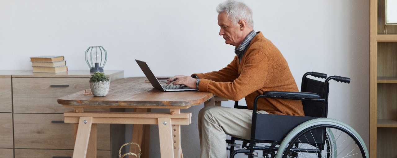 Older Gentlemen in a Wheelchair on a Laptop