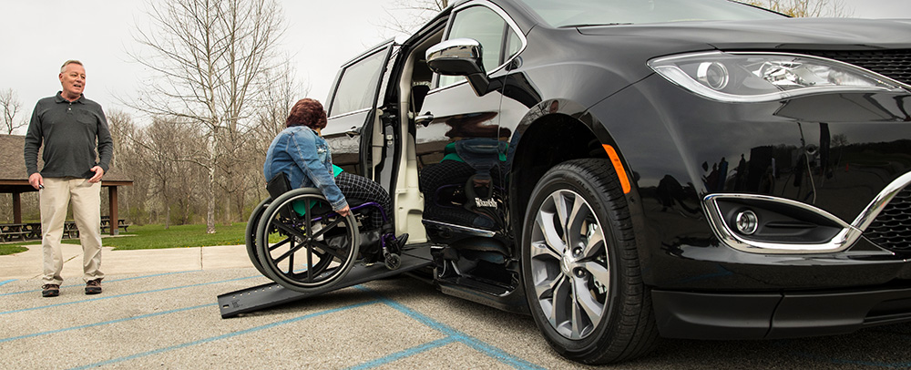 Women in a Wheelchair goes up a Ramp into her Handicap Van