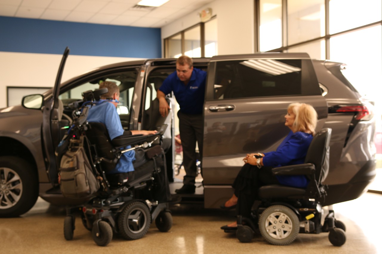BraunAbility employees' helping customer buy a Handicap Van