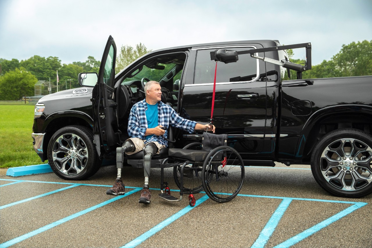 Man using a accessible truck to get into wheelchair
