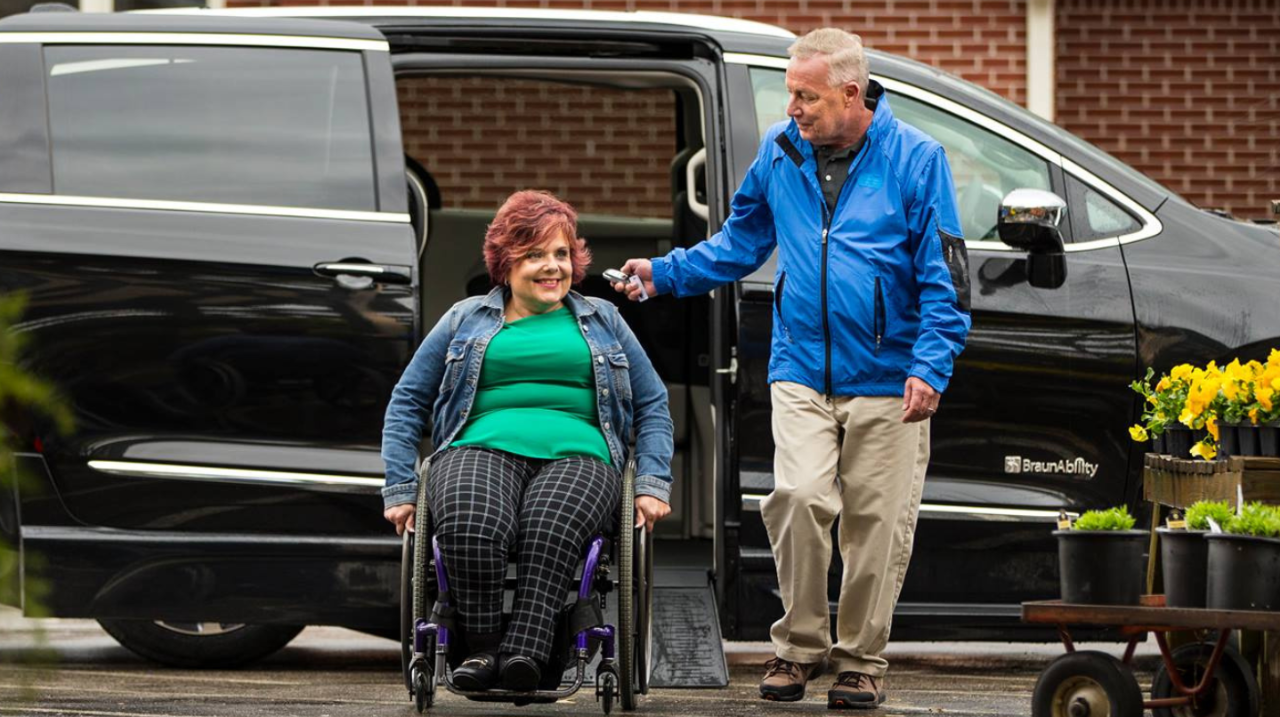 Women using a ramp to get out of her Wheelchair accessible vehicle. 