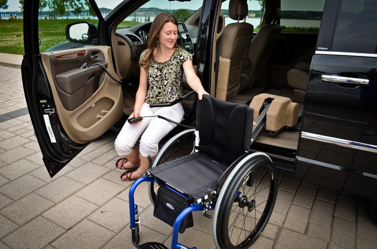 BraunAbility Wheelchair Van assisting a Lady get into Wheelchair