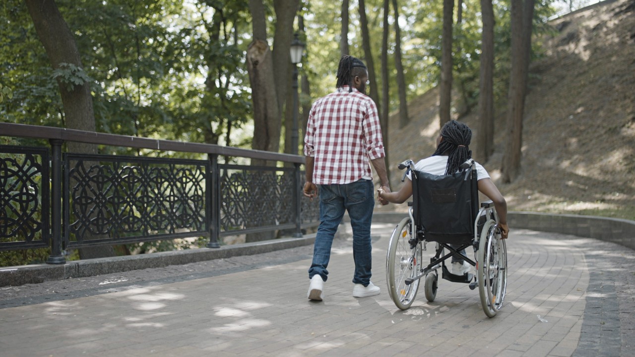 Man and Woman in Wheelchair going on a walk