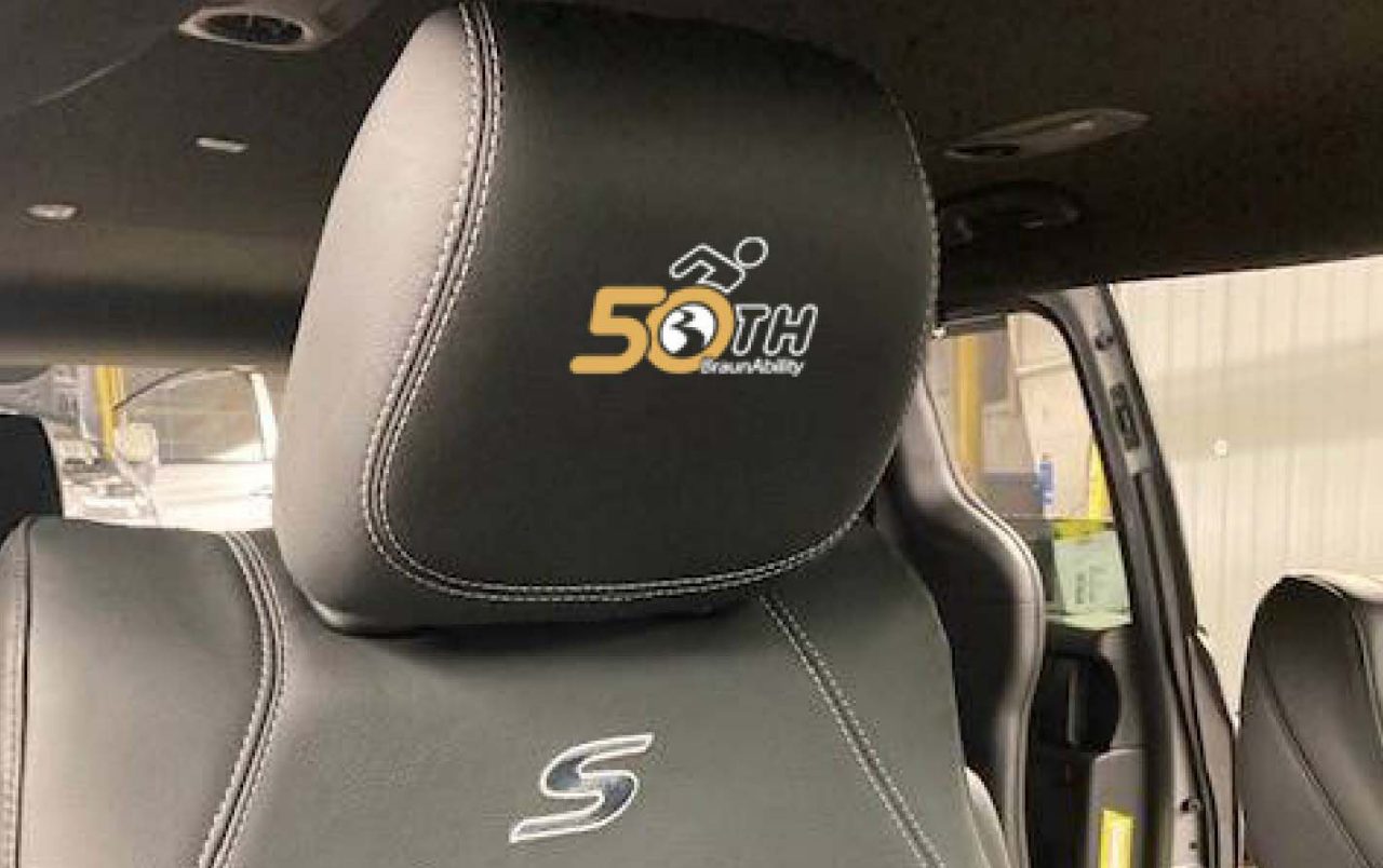 Closeup of a seat headrest with an embroidered BraunAbility 50th anniversay logo