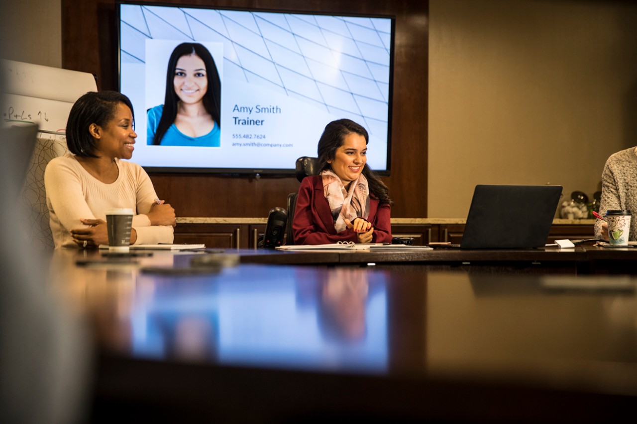 woman in wheelchair at conference table