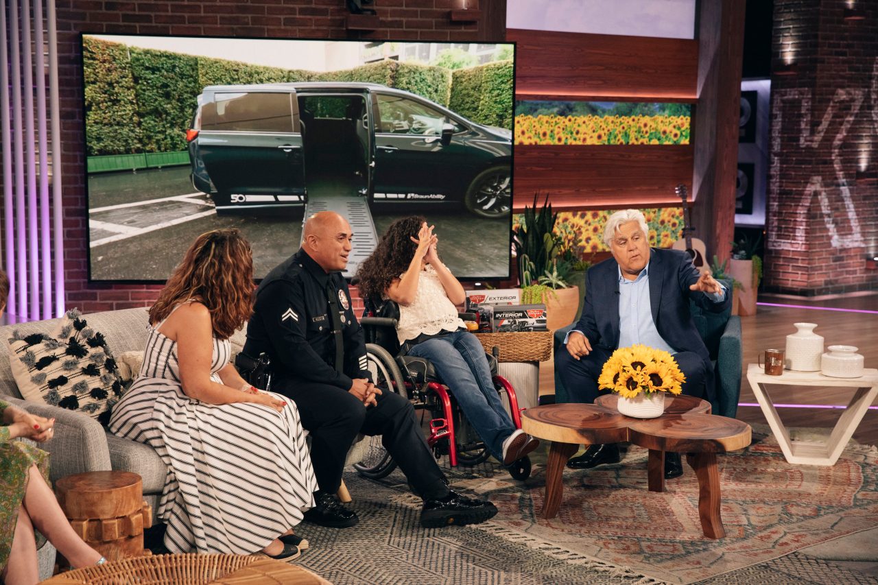Arrue family on couch on the set of the Kelly Clarkson show with Jay Leno presenting to them.