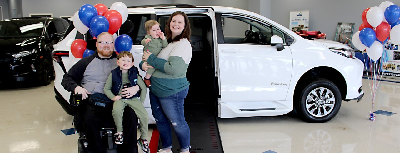 Officer Dustin Moody and his family receive a red carpet introduction to their new BraunAbility wheelchair van, made possible by community and business donations.