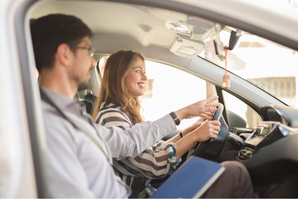 a driving evaluator and a woman in a car