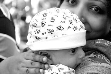 Neena Nizar holding her baby