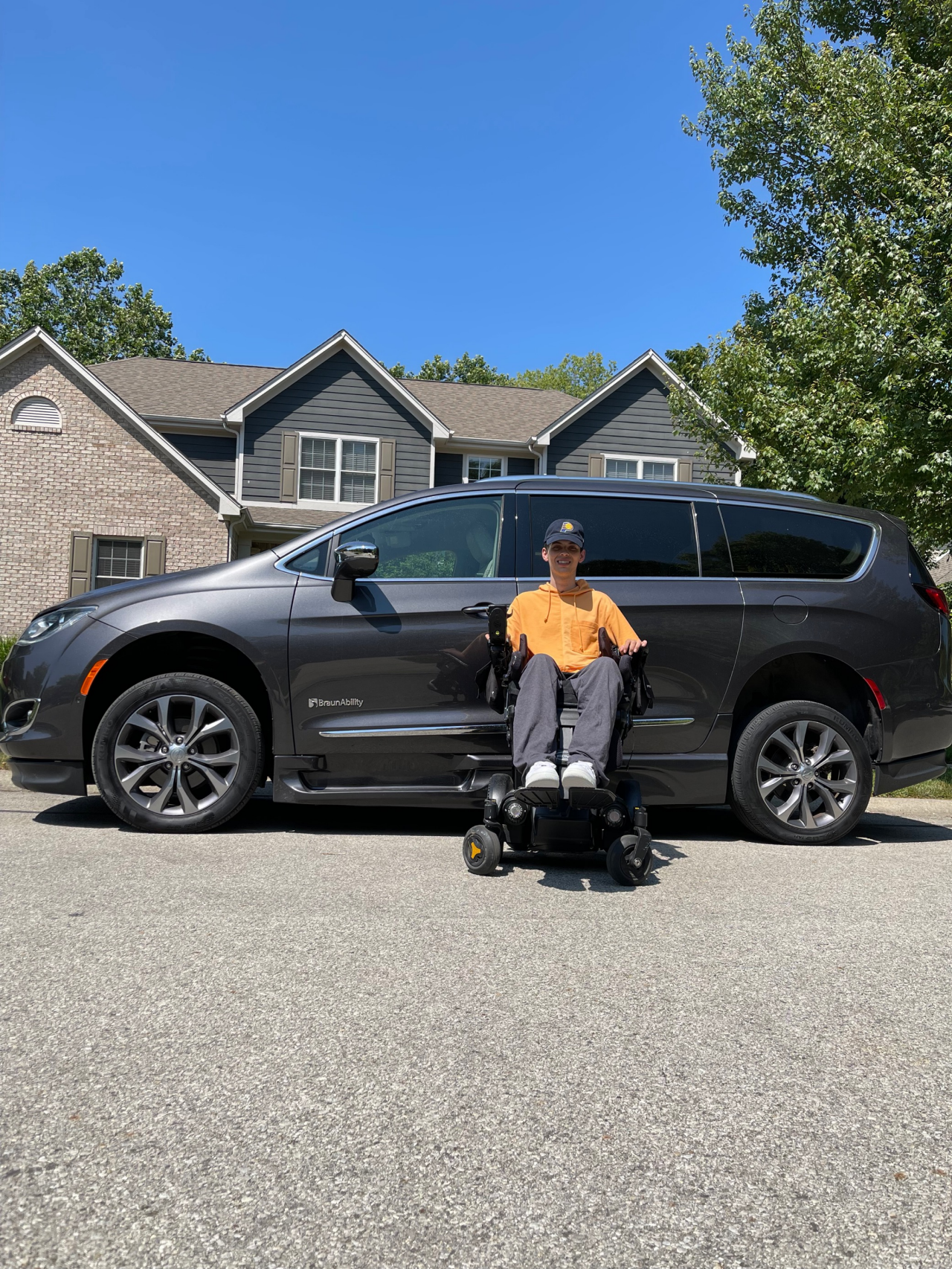 Josh Fugate in his wheelchair in front of a BruanAbility van