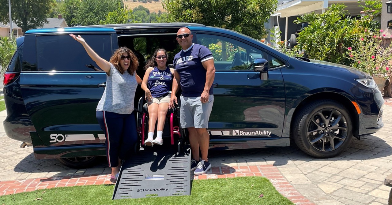 Arrue family outside with their new BraunAbility Chrysler Pacifica
