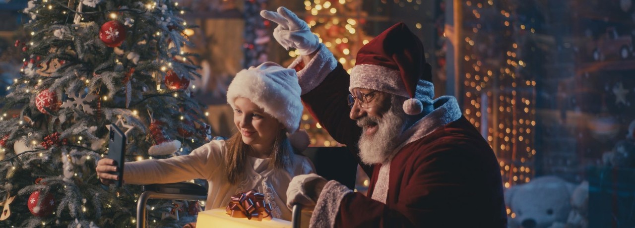 girl taking a photo with santa