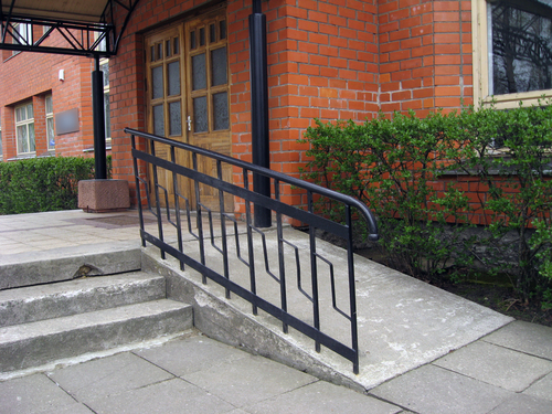 Building entrance with ramp for disabled person wheelchair