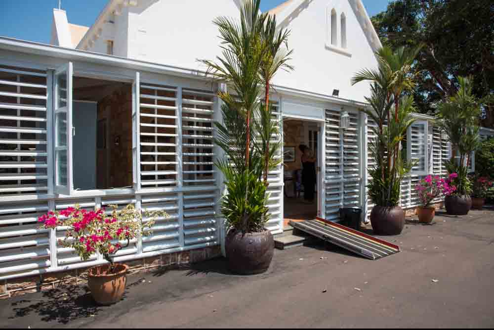 A house with a small ramp for doorway Darwin, Northern Territory, Australia-September 1, 2018: The Government House with victorian gothic architecture and tropical plants in Darwin, Australia