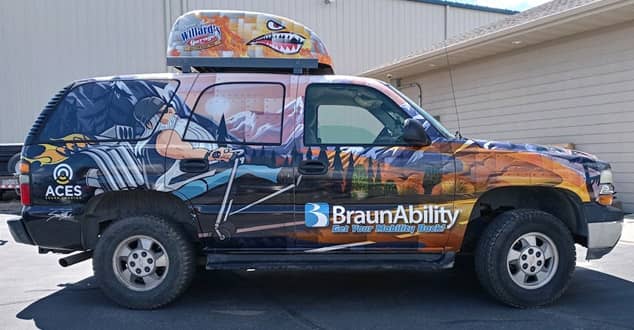 Chair topper on top of a BraunAbility wraped SUV