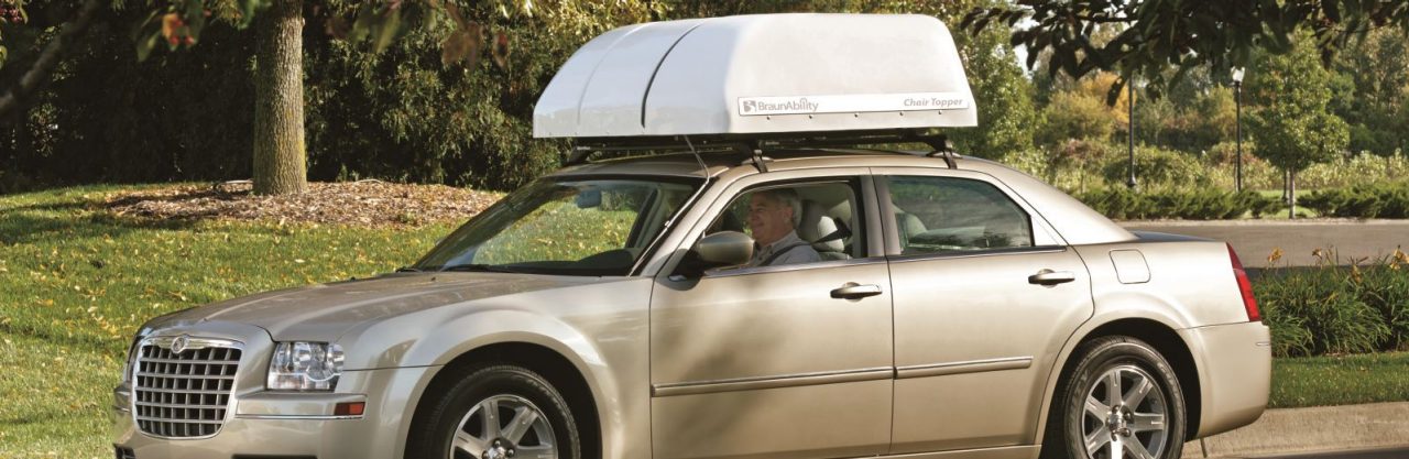 BraunAbility Chair topper on top of car with an older couple driving