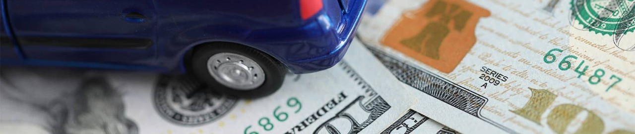 toy car sitting on money