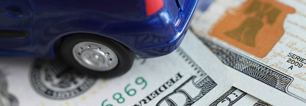 toy car sitting on money