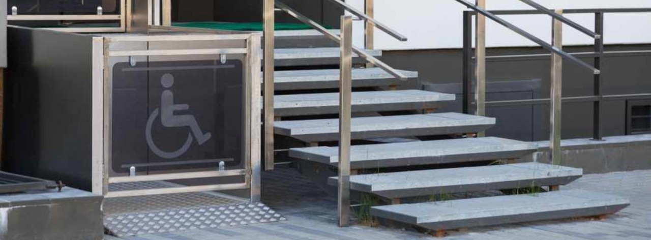 Platform lift next to wooden stairs