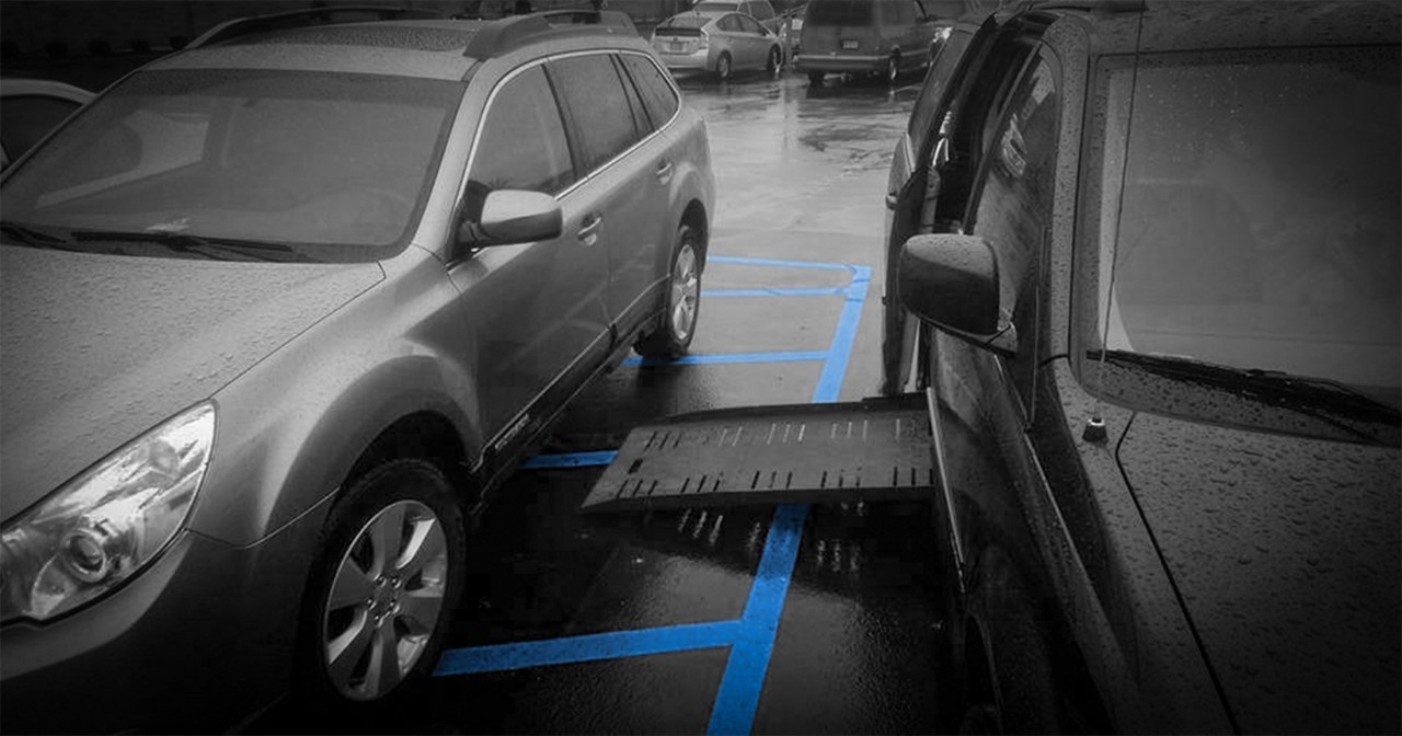 Car parked in access aisle which is blocking access to the handicap van