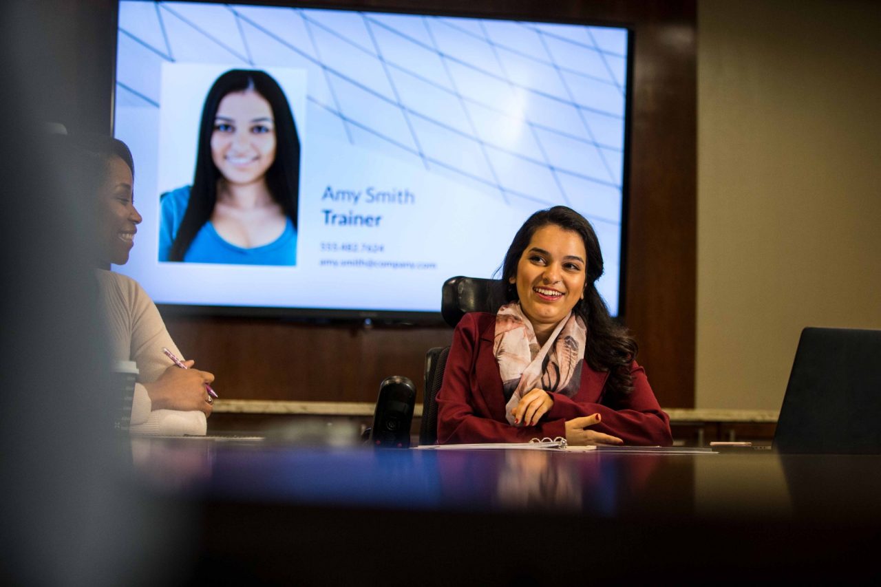 Woman in power chair in conference room