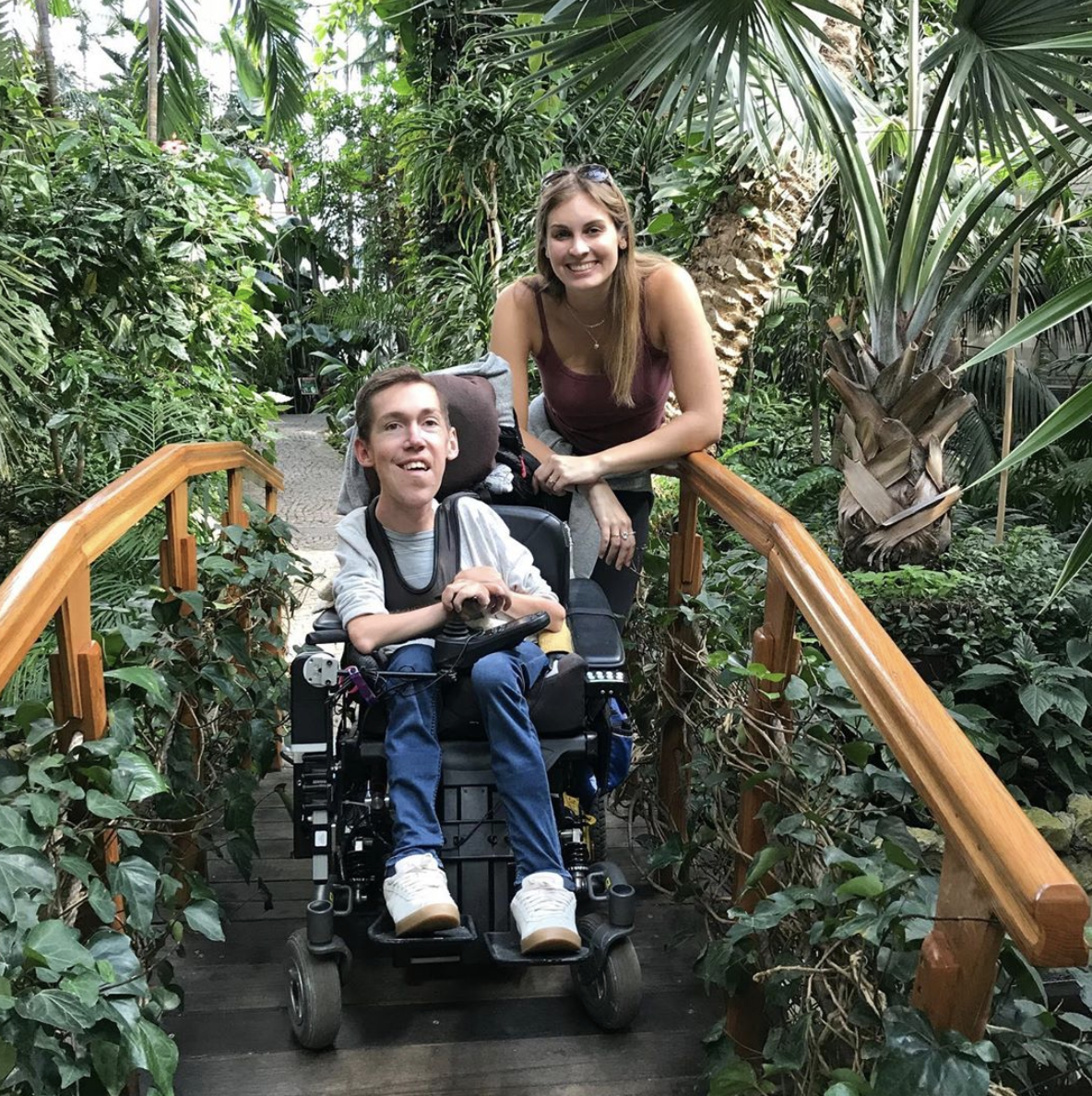 Shane Burcaw and Hannah Aylward crossing a bridge 