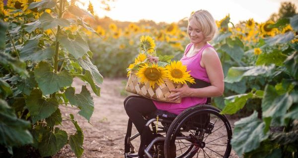 click here to take the wheelchair van lifestyle survey-woman collecting sunflowers