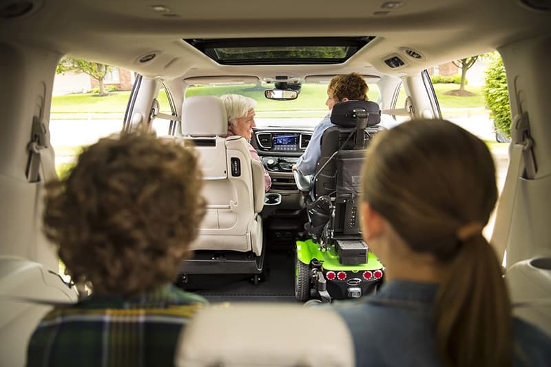 a family riding in a wheelchair van for rent