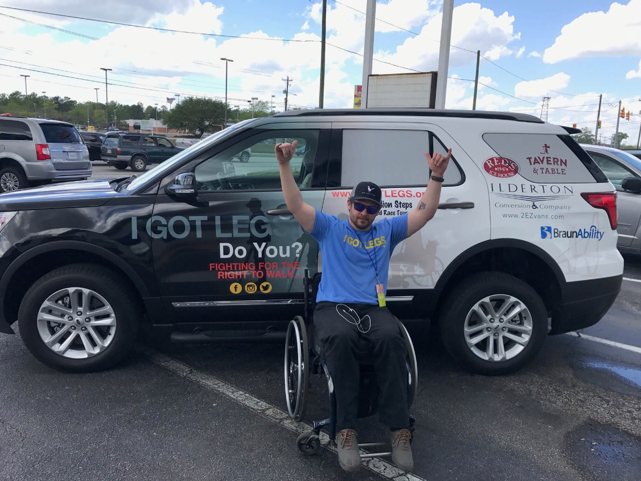Adam Gorlitsky sits in a wheelchair in front of a BraunAbility MXV and raises his hands in triumph Adam Gorlitsky sits in a wheelchair in front of a BraunAbility MXV and raises his hands in triumph