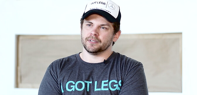 Adam Gorlitsky wears I GOT LEGS merchandise while being interviewed