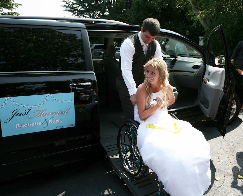Rachelle Chapman is wheeled out of a BraunAbility vehicle by her new husband