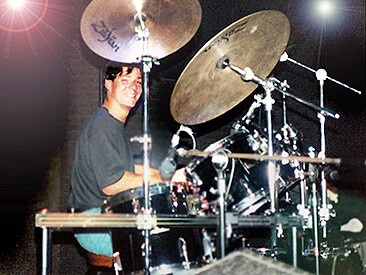 Young Jason Gerling smiles from behind a drumset Young Jason Gerling smiles from behind a drumset
