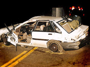 Wrecked white car as seen at night Wrecked white car as seen at night