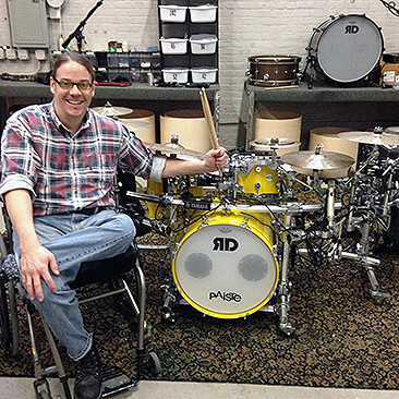 Jason Gerling sits in his wheelchair and poses with his modified drum kit Jason Gerling sits in his wheelchair and poses with his modified drum kit