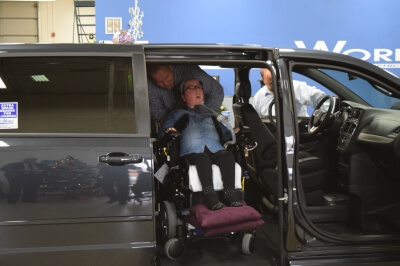 Lauren Gross exits a side-entry BraunAbility vehicle in a MobilityWorks dealership Lauren Gross exits a side-entry BraunAbility vehicle in a MobilityWorks dealership