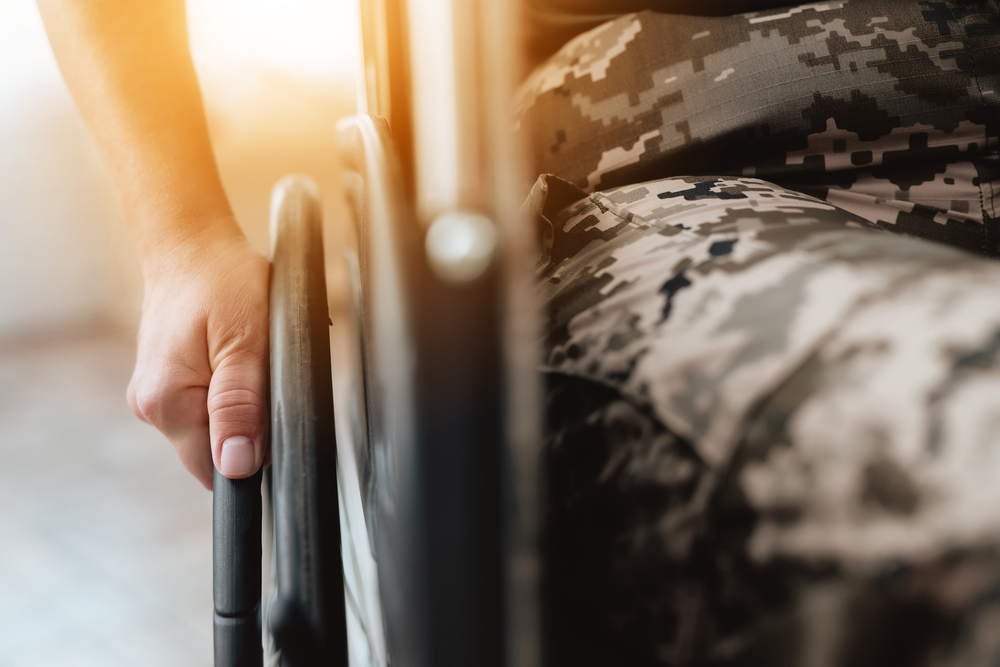 Veteran right hand on the wheel on the wheelchair