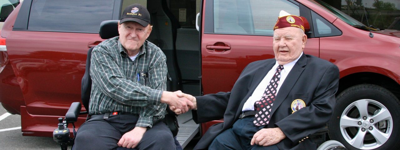 Two Veterans in Wheelchair shaking hands